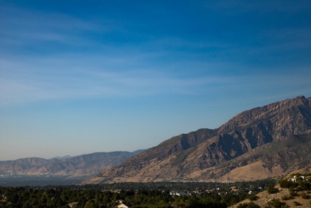A rugged mountain range rises above a valley