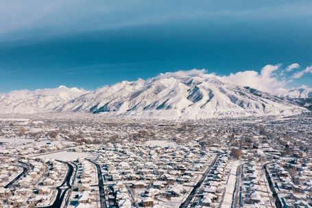 An aerial view shows a snow-covered residential town