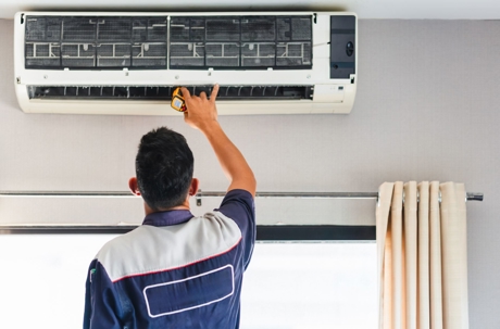 An AC unit is being repaired