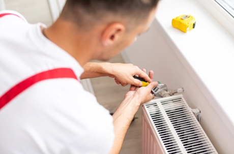 A technician is repairing a Heating