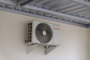 aging outdoor AC unit in a dusty Utah backyard during summer heat