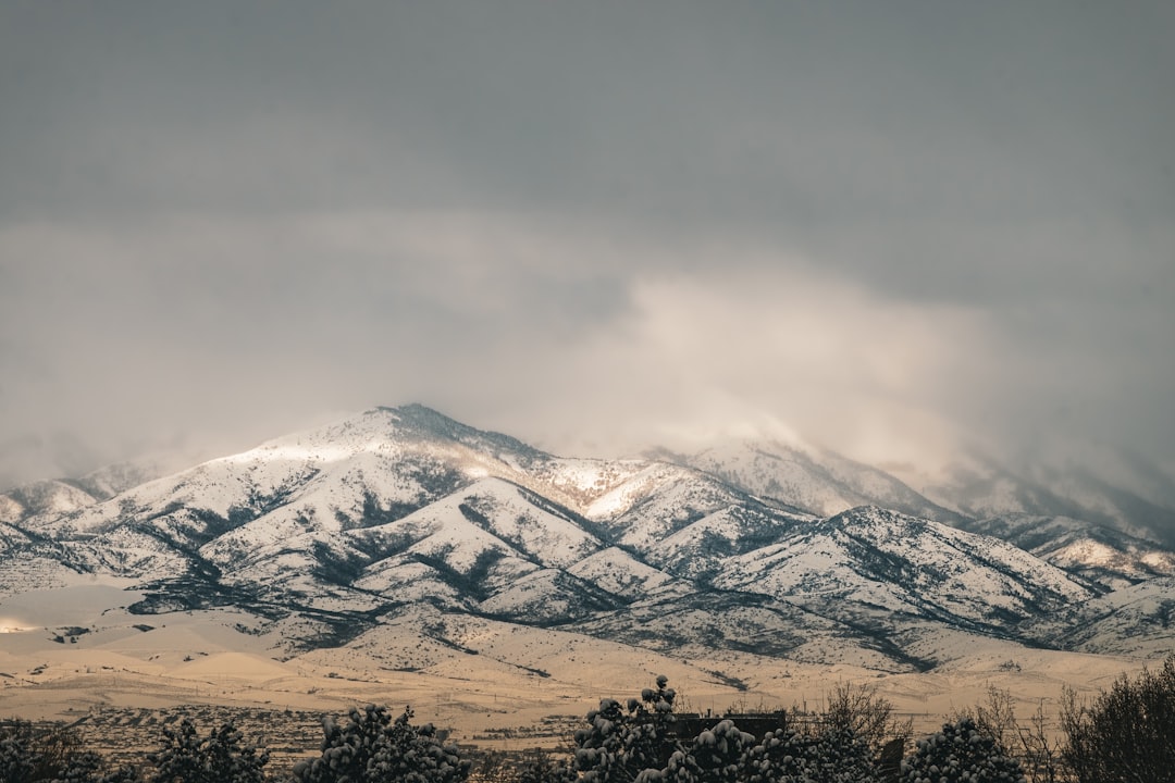 heat pump operating in snowy Utah yard with Wasatch Front in background